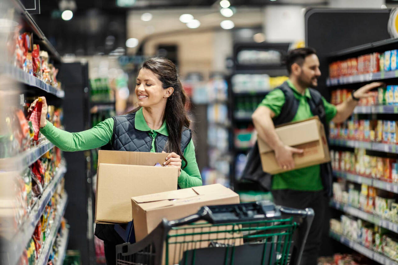 the-employees-arranging-groceries-on-shelves-in-supermarket